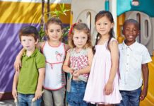 Locker Room Rules Ignite YMCA Firestorm Five children standing together in a playground setting, smiling at the camera