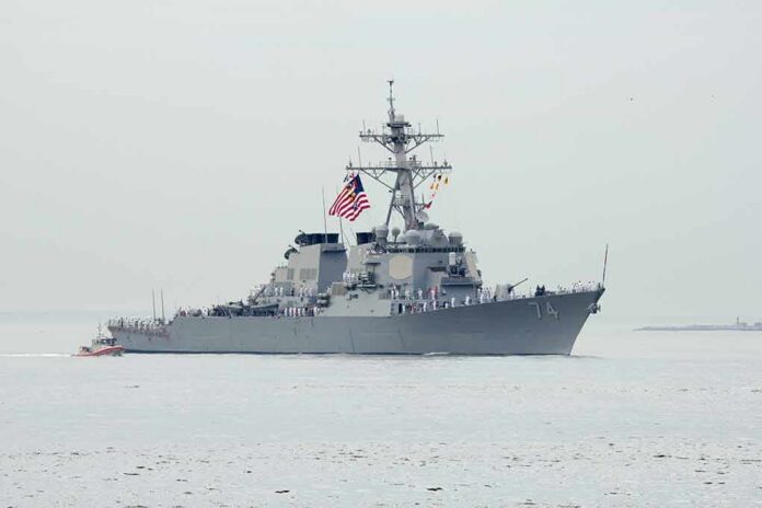 shutterstock_194541611 Navy destroyer with crew lined on deck at sea