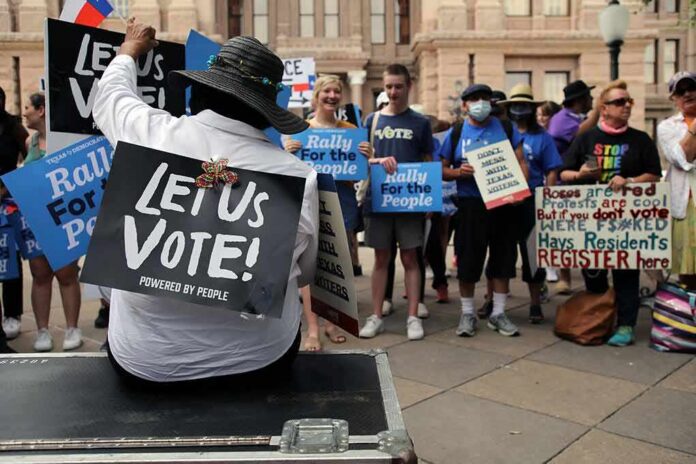 Protesters holding signs at a voting rights rally