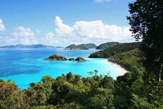 shutterstock_24886447 Scenic view of a tropical beach with clear blue water and lush greenery