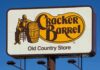 Cracker Barrel roadside sign with logo against blue sky