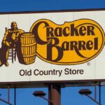 Woke Rebrand Backfires — CEO Out Cracker Barrel roadside sign with logo against blue sky