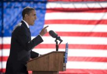 Fact Check Slams Explosive Obama Claim Speaker at podium with microphones in front of US flag