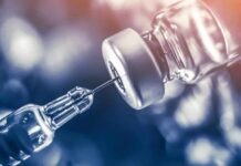Tiny Habit, Big Hit: Nicotine Wrecks GLP-1 syringe needle drawing liquid from a vaccine vial