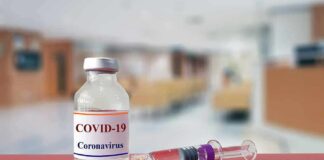 vaccine vial and syringe on a counter in a clinic