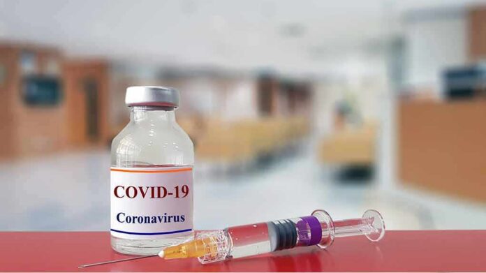 shutterstock_1643122693 vaccine vial and syringe on a counter in a clinic