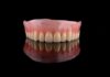 Upper denture on black reflective surface