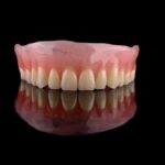 Upper denture on black reflective surface