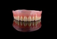 Fake Dentist Vanishes — FBI Scrambles Upper denture on black reflective surface