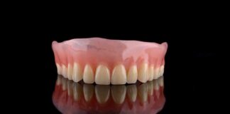 Upper denture on black reflective surface