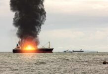 Trade Lifeline Attacked — Crew Barely Saved Cargo ship on fire with thick black smoke at sea