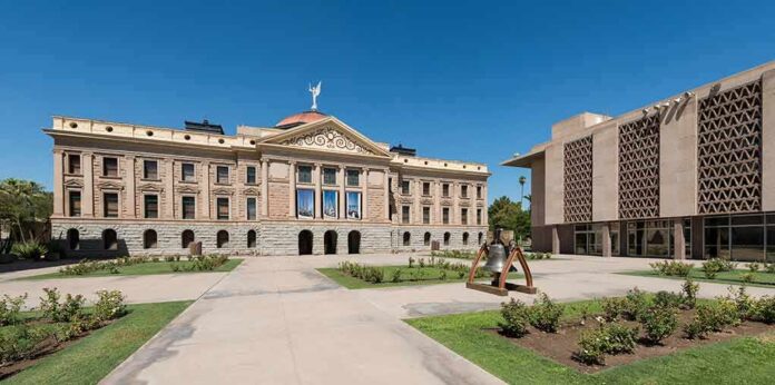 shutterstock_212407786 Historic capitol building with landscaped courtyard under clear blue sky