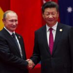 two men in suits shaking hands