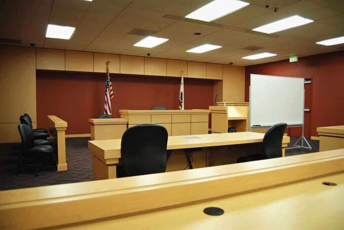 shutterstock_6768826 Interior view of an empty courtroom with wooden furniture and American flags
