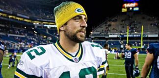 football player in white jersey and yellow beanie on the field