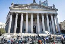 LGBTQ Protections Rolled Back – What’s Next? Reporters and photographers gathered outside a neoclassical courthouse