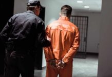 Courthouse Chaos: Cuffs Snap, Deputy Dropped Police officer escorting handcuffed inmate in orange jumpsuit