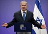 UN Trip Sparks Arrest Power Fight man in suit speaking at a podium with Israeli flag