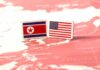 Flags of North Korea and the United States on a map of East Asia