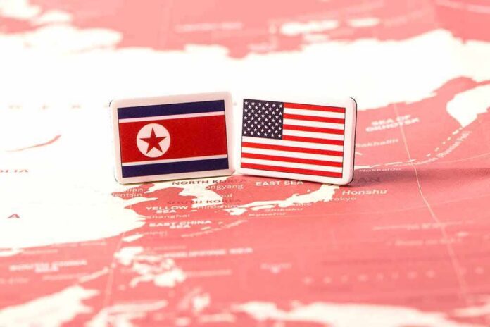 Flags of North Korea and the United States on a map of East Asia