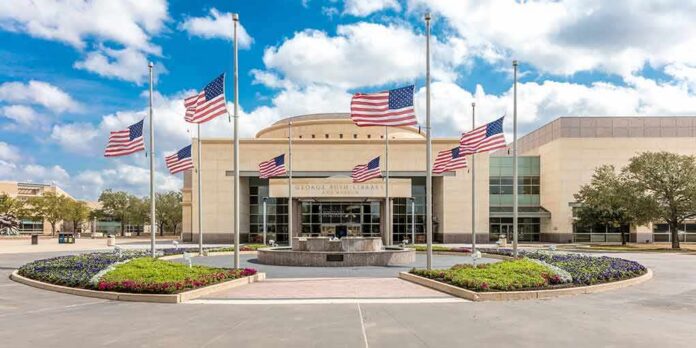 shutterstock_1090472669 American flags at half-staff around a library entrance