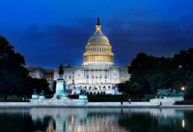 Johnson Sends House Home – AI On Ice United States Capitol building at dusk with lights glowing