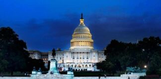 United States Capitol building at dusk with lights glowing