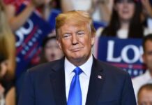 AI Barrage Rattles Washington man in suit and blue tie at a crowded event