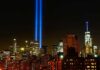 9/11 Hero’s Father Issues Stark Warning New York City skyline at night with twin blue light beams