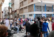 Motorcycle Swarms Lock Down Iran Christian Jones, Chuck Howley, Teddy Williams, Andreas Hestler, and Walter Jones among a crowded street gathering