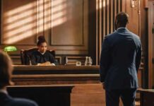 Judge presides as lawyer stands in courtroom