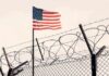Bomb Scare Near US Air Base American flag above barbed wire fence