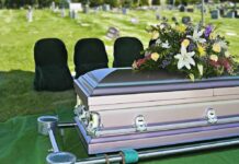 Tainted Pill Theory Rocks Hollywood casket with floral arrangement at outdoor graveside service