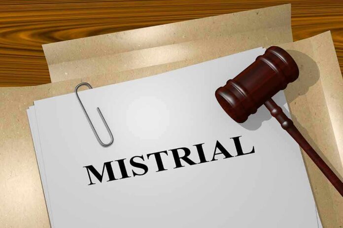 Gavel and file labeled mistrial on a desk