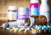 Three-Week Rule Could Save Lives Medicine pills and syringe on table with brown bottle