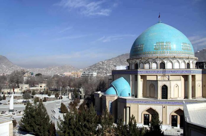 shutterstock_668065708 Blue-domed mosque with mountains in the background