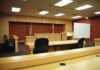 Mayor Walks After Teen Sex Conviction Interior view of an empty courtroom with wooden furniture and American flags