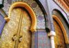 ornate golden doors with colorful mosaic arches