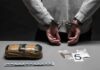 person in handcuffs behind back over table with seized packages