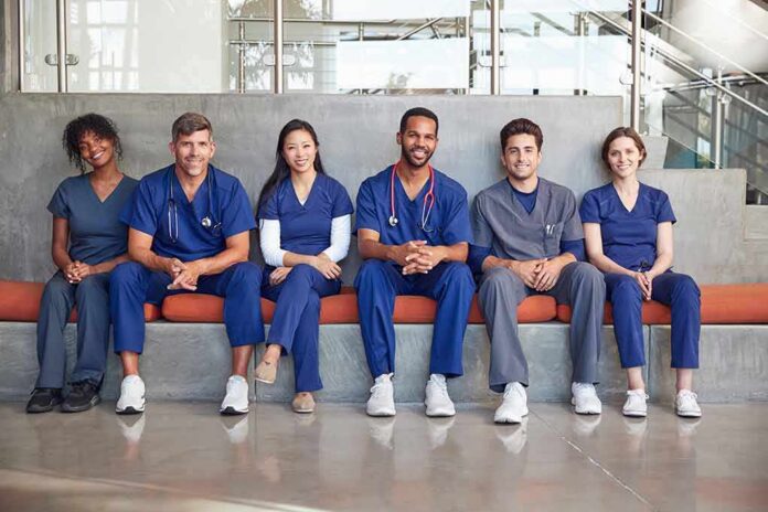 shutterstock_1133220080 Group of medical professionals sitting on a bench