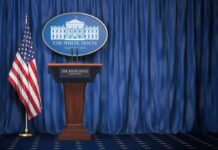 Court Smackdown Halts Trump Media Purge White House press briefing podium with U.S. flag and blue curtain