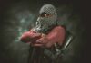 Sister’s Claim Rattles El-Sayed Campaign armed person with face covered crossing arms