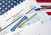 JD Vance Freezes Microsoft Green Cards immigration forms with green card and social security card on US flag background