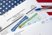 JD Vance Freezes Microsoft Green Cards immigration forms with green card and social security card on US flag background