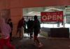 Protest Chaos Triggers Precrime Policing People outside a storefront with broken glass at night