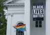 Rainbow Flyer Sparks Legal Fire Black Lives Matter banner and rainbow pride flag on white building