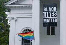 Rainbow Flyer Sparks Legal Fire Black Lives Matter banner and rainbow pride flag on white building