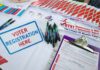 Texas Power Play: Musk Money Moves Voter registration table with forms, pens, and informational materials