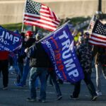 Nicki Minaj Twist at Trump Rally Crowd of people carrying political and American flags at a street gathering