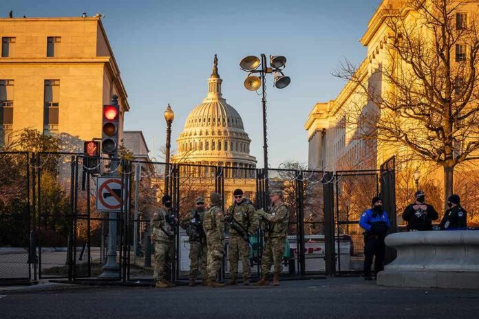 National Guard troops stand at a security fence near the U.S. Capitol
